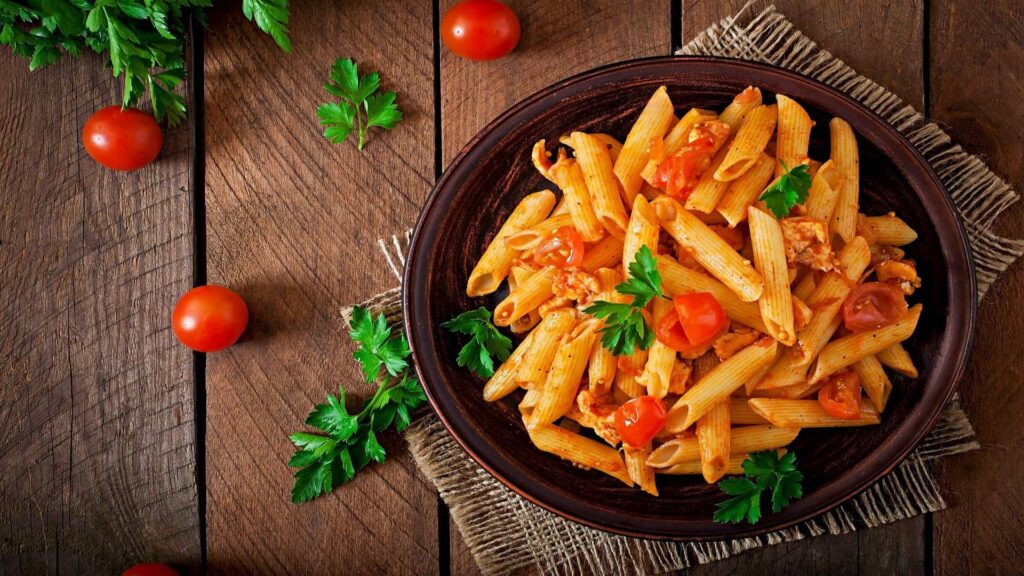 Penne pasta with tomato sauce and fresh herbs, served in Italian style.