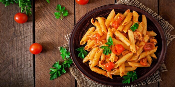 Authentic Italian pasta with penne, tomato sauce, and fresh herbs served in Italian style